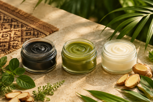 Three unbranded Thai herbal balm jars in black, green and white on a tropical stone setting